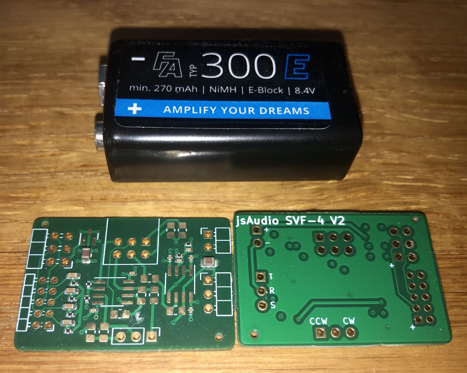 Two PCBs and a 9V battery. One PCB shows the front of the circuit with some components assembled, the other shows the back of the circuit with a silkscreen “jsAudio SVF-4 V2”